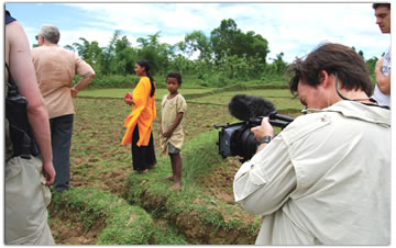 (Pictured) Overlooking India in the rice fields of a small village outside Srimangal. John gets hit with a ‘bug,’ and two crew members don’t make that portion of the trip either because of illness. So William films most of the day.