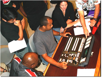 Rolf Mendez, a Cinema-Television professor at Los Angeles City College, instructs students on the functions of the FOR-A HVS-1500HS switcher.