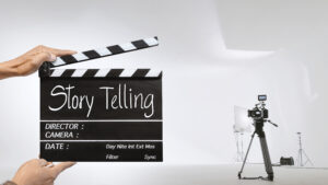 Story telling, Handwriting on film slate or clapperboard .film crew holding film clapperboard and a camera filming a movie in the studio.